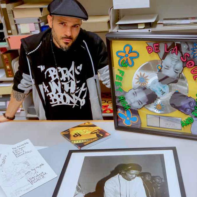 		person sitting with records and other items around them
	