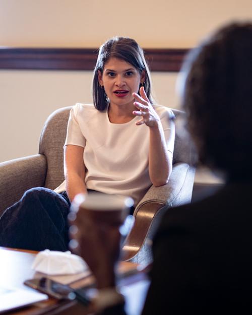 		Person sitting in a chair, speaking dynamically
	