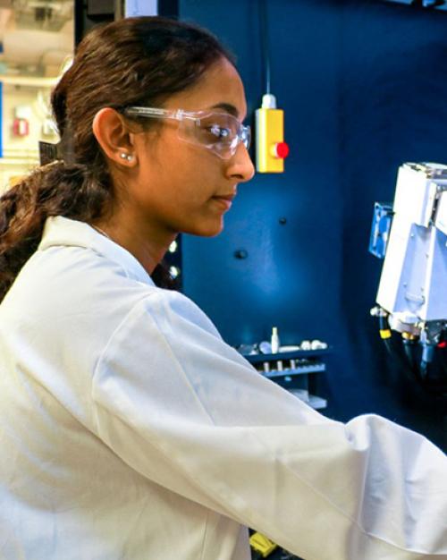 		Person in lab coat operating machinery
	