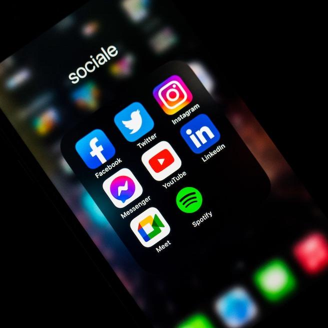 Social media icons glow on a smart phone
