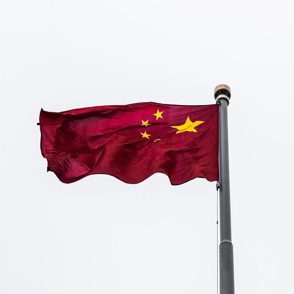 Red flag against a white sky