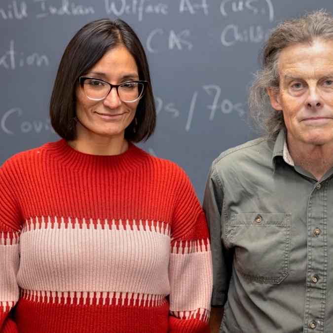two people standing by blackboard