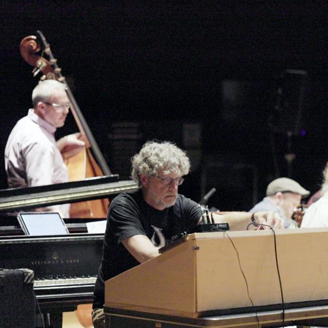 		Four people on a stage, with instruments
	