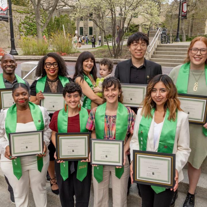 		Eight people wearing green academic stoles (plus one baby)
	