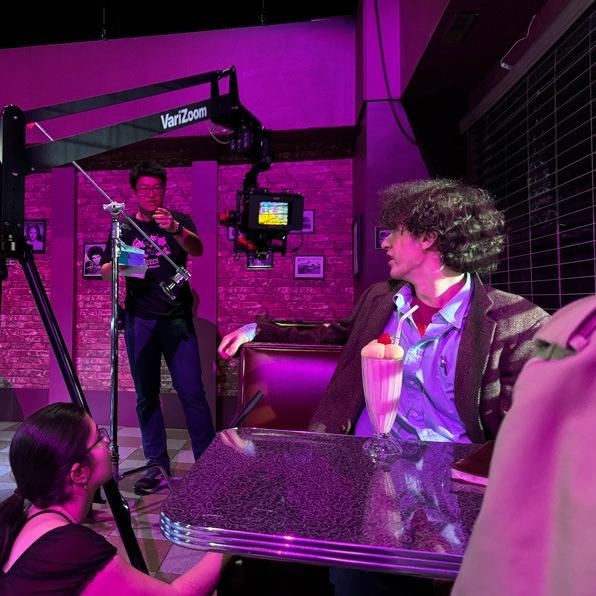 People on the dimly-lit set of a film