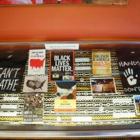 Books in a display case; colored cloth background