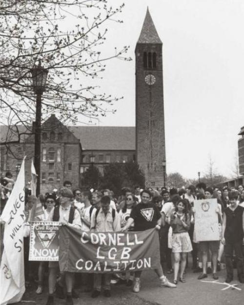 Black and white photo of people at a rally