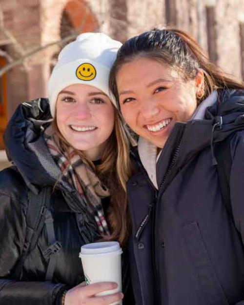 two women students outside in the snow