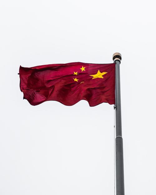 Red flag against a white sky