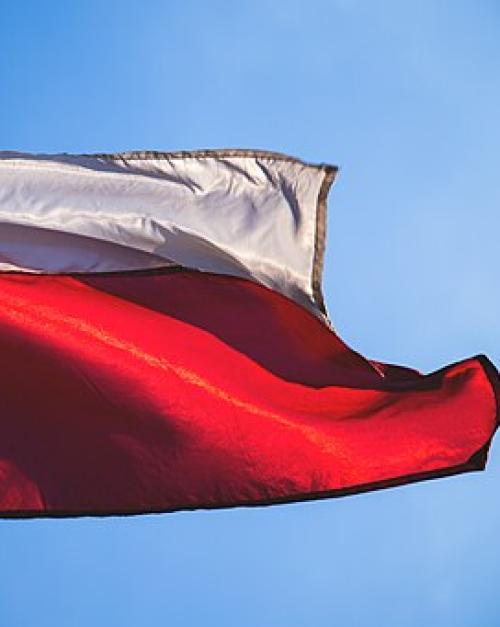 Portion of a billowing flag, white stripe on top red stripe on bottom