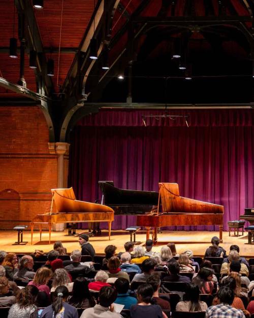 		three pianos on a stage
	