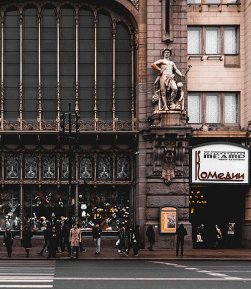  People in drab clothes on a sidewalk