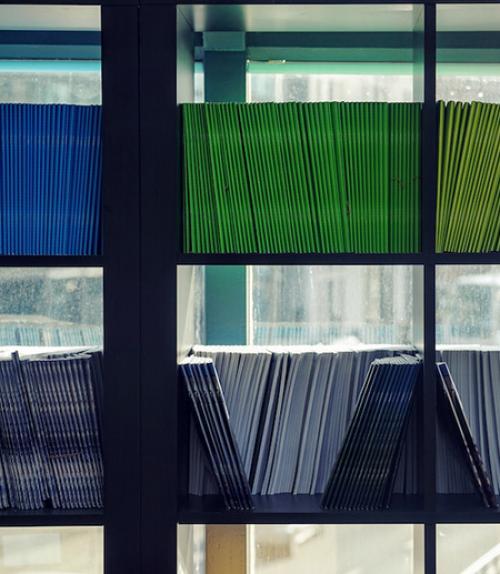  Journals on shelves in front of a window