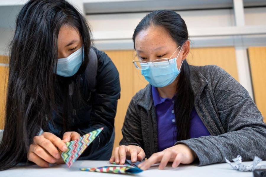 Members of the Cornell community attempt some origami during the event.